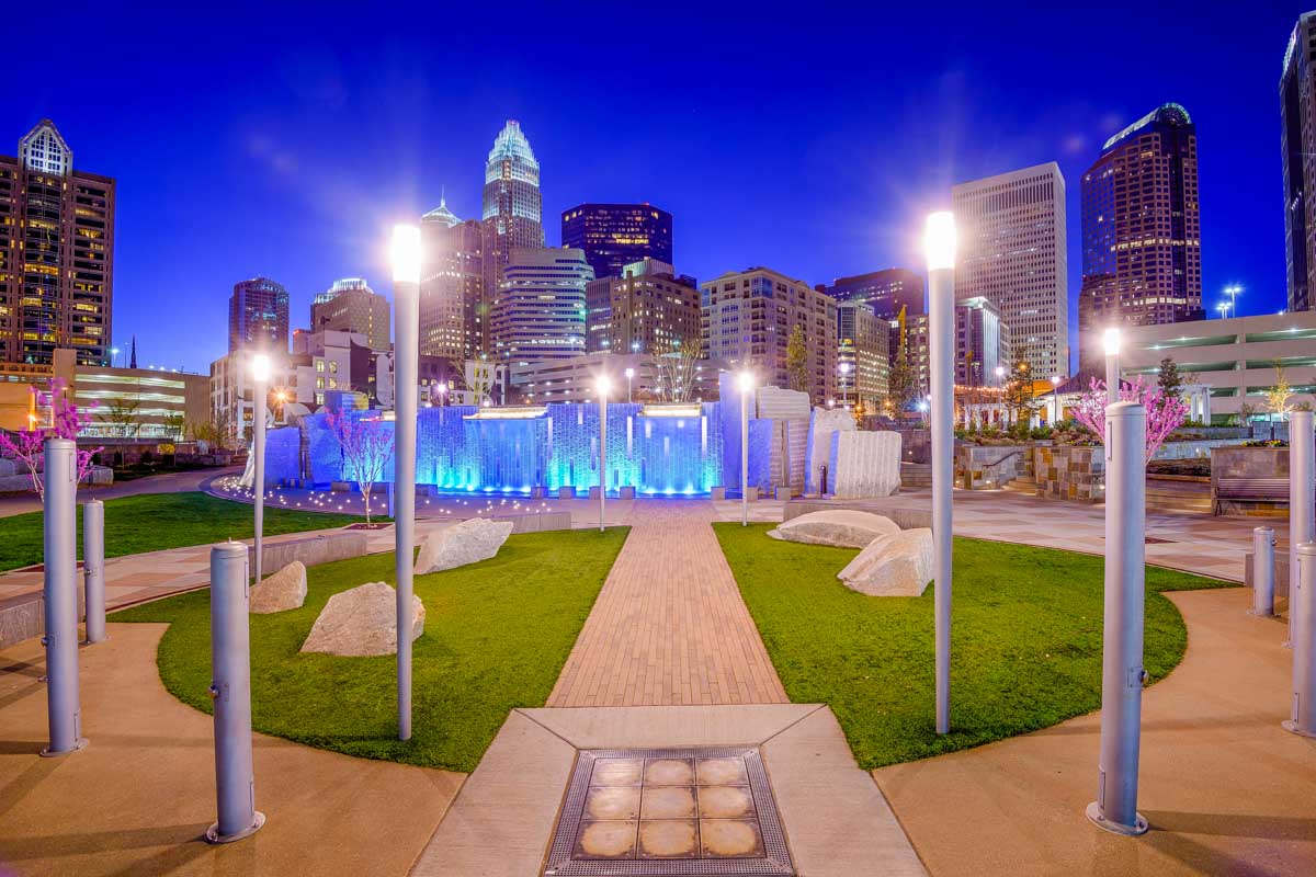 Romare Bearden Park at night with Charlotte skyline behind it